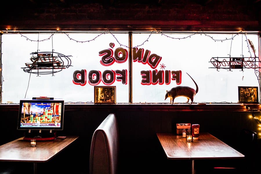 Booths and tables inside Dino's bar